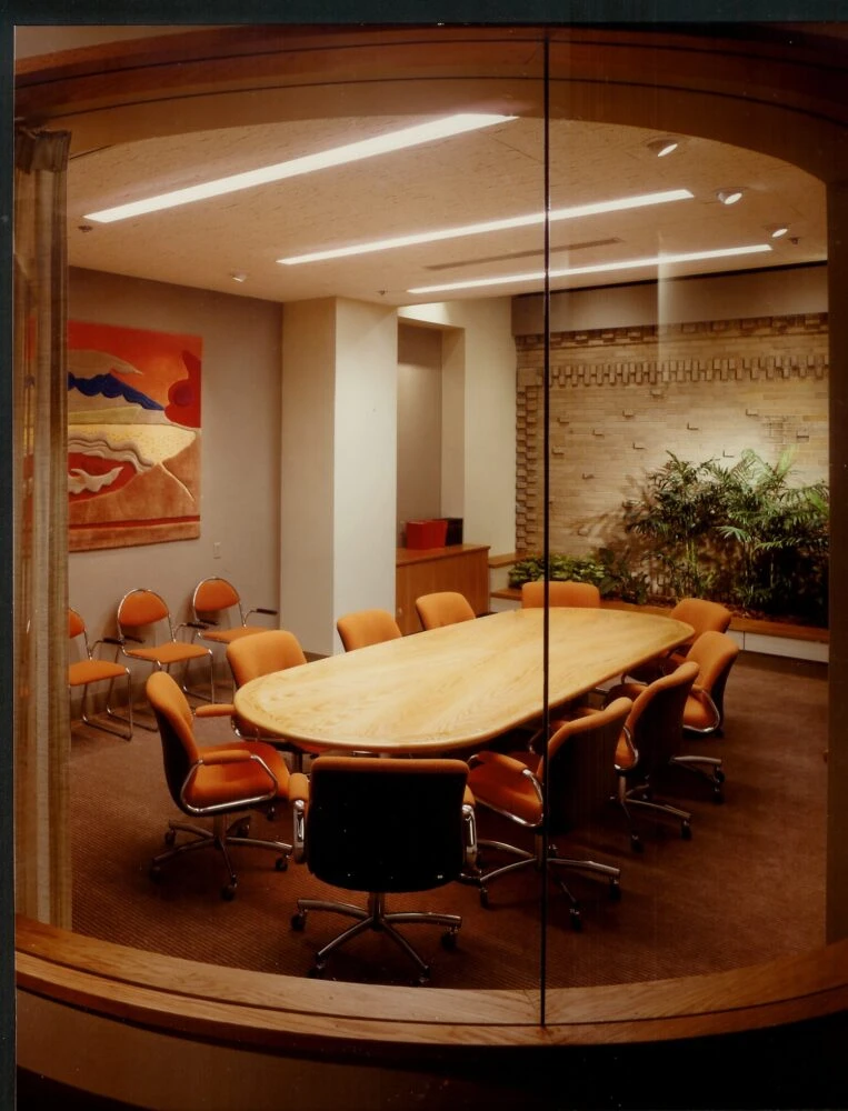 A Conference Table Surrounded by Chairs in a Well-Lit Meeting Room.